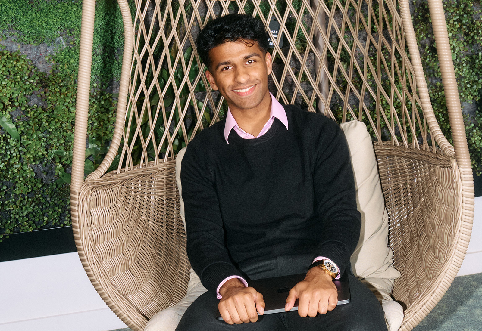 a person sitting in a wicker chair