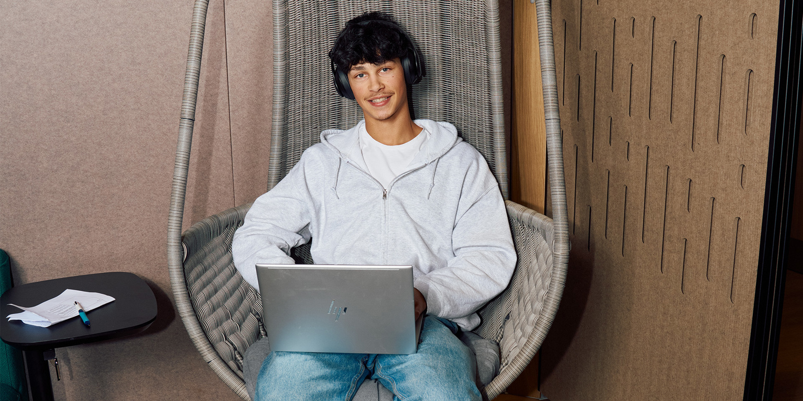 a person sitting in a chair with a laptop
